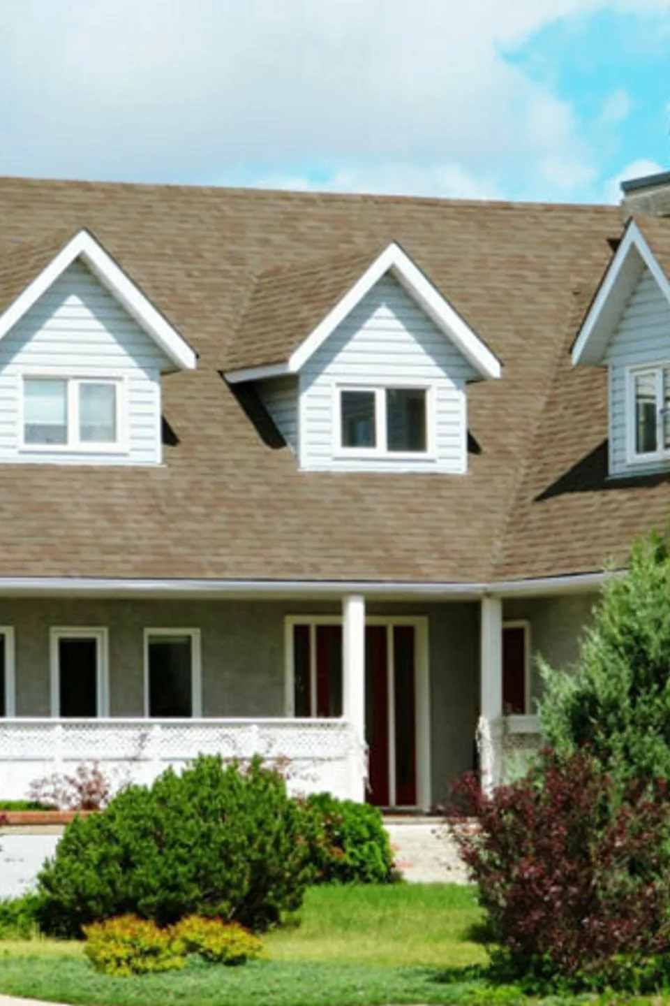 Home with a new brown shingle roof and three dormers