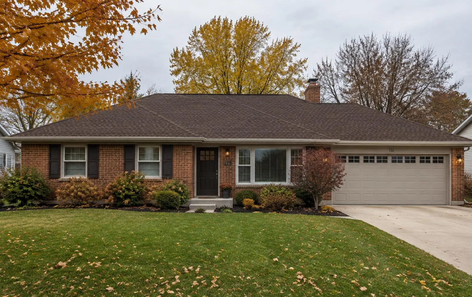 Brick ranch home with a new brown shingle roof near Forest Park, Ohio